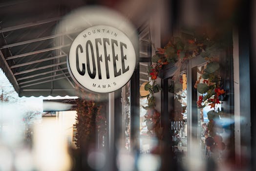 Cozy coffee shop exterior with festive wreaths and inviting atmosphere.