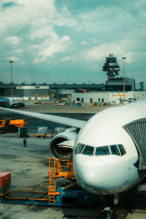 Free Front view of a commercial airplane at Hong Kong International Airport's terminal. Stock Photo