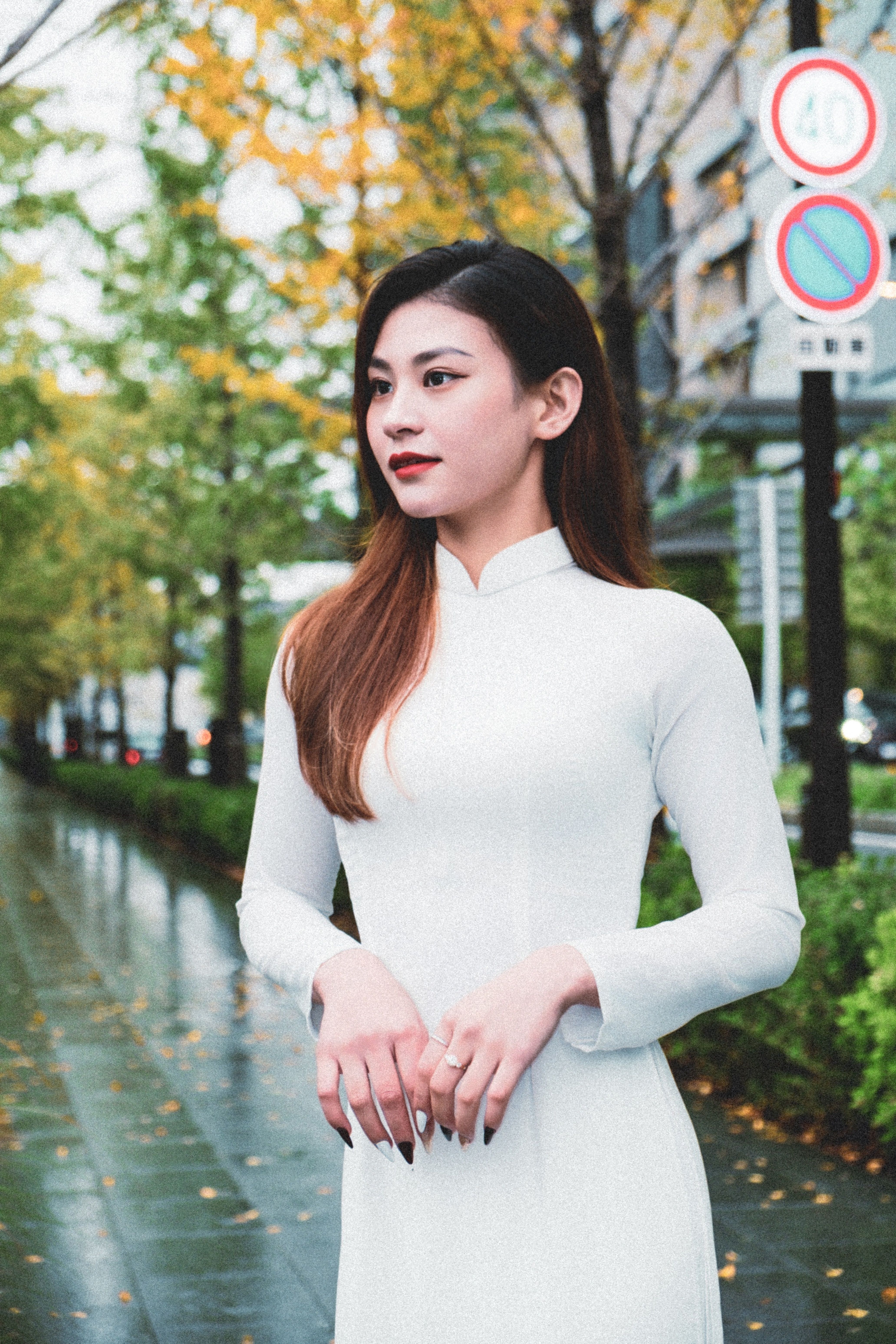 Elegant Young Woman in White Dress on a Rainy Day · Free Stock Photo