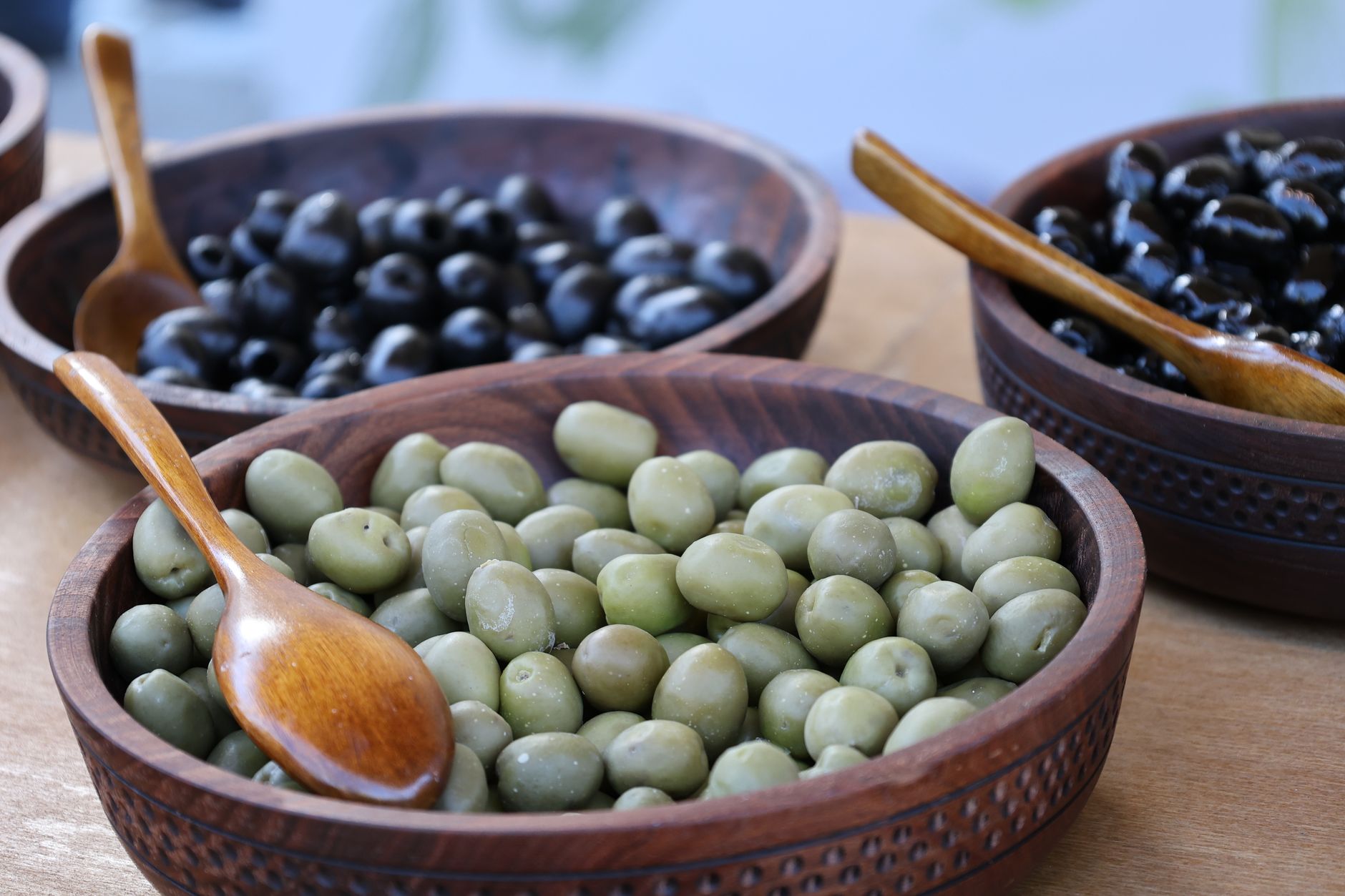 Close-up of fresh green olives with leaves