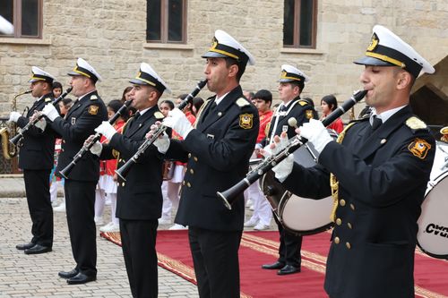 Free A military band in uniform performing with clarinets and saxophones during an outdoor ceremony. Stock Photo