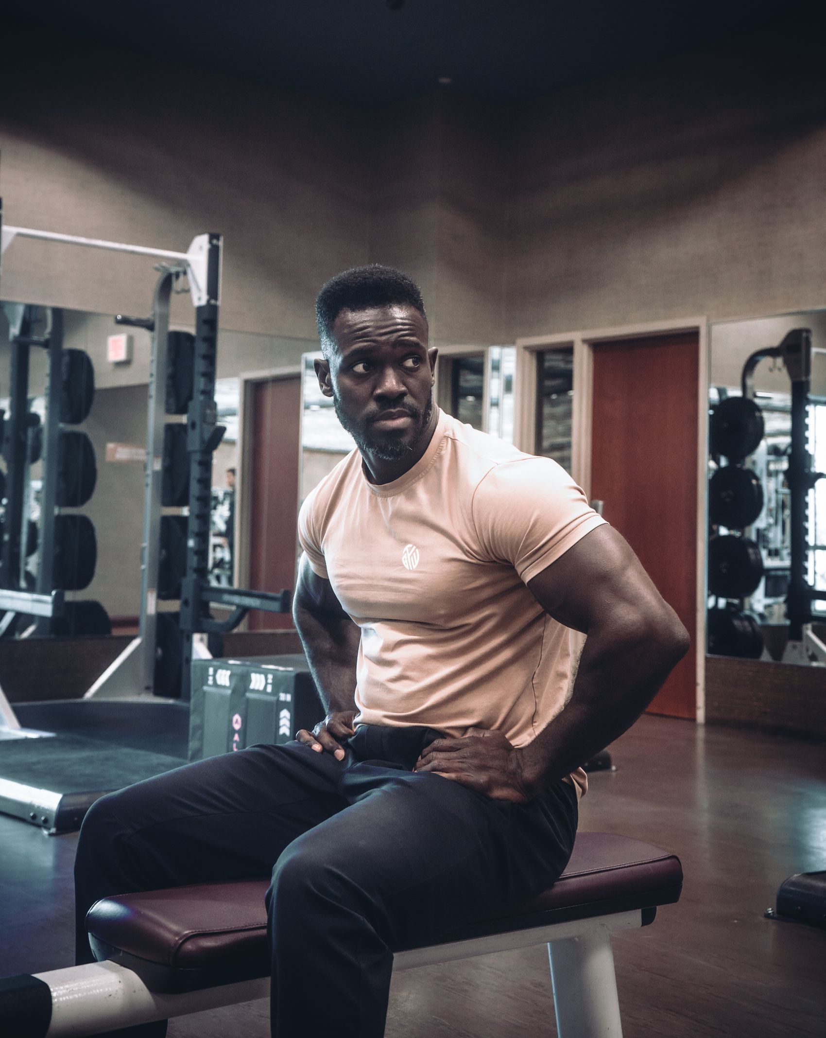 Muscular athlete training with weights in a modern gym