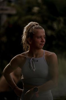 A young woman in activewear takes a break during her outdoor run, embodying fitness and motivation.