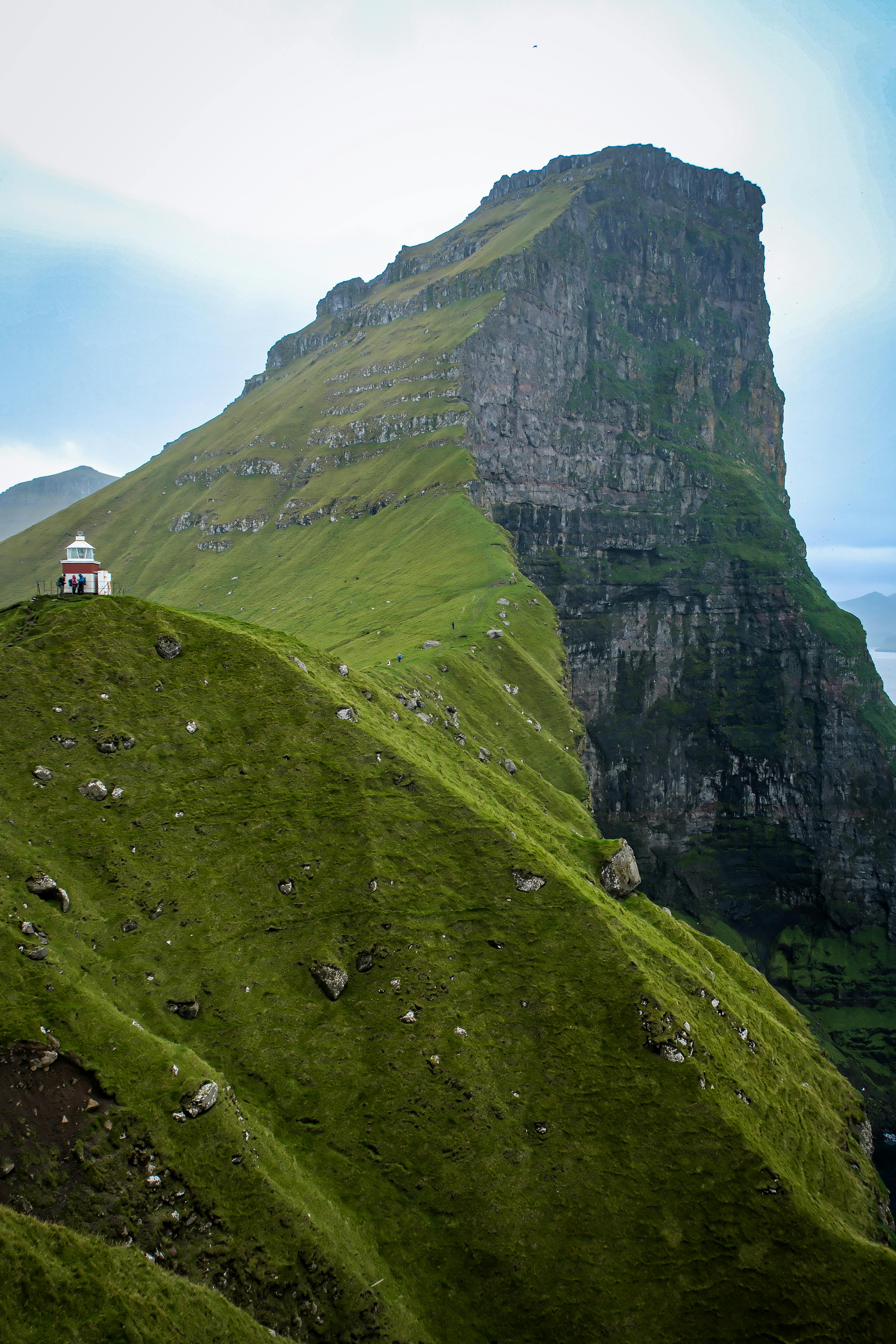 Stunning view of Klakkur Mountain's green cliffs in Trøllanes, Faroe Islands.