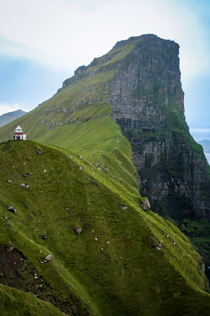 Stunning view of Klakkur Mountain's green cliffs in Trøllanes, Faroe Islands.