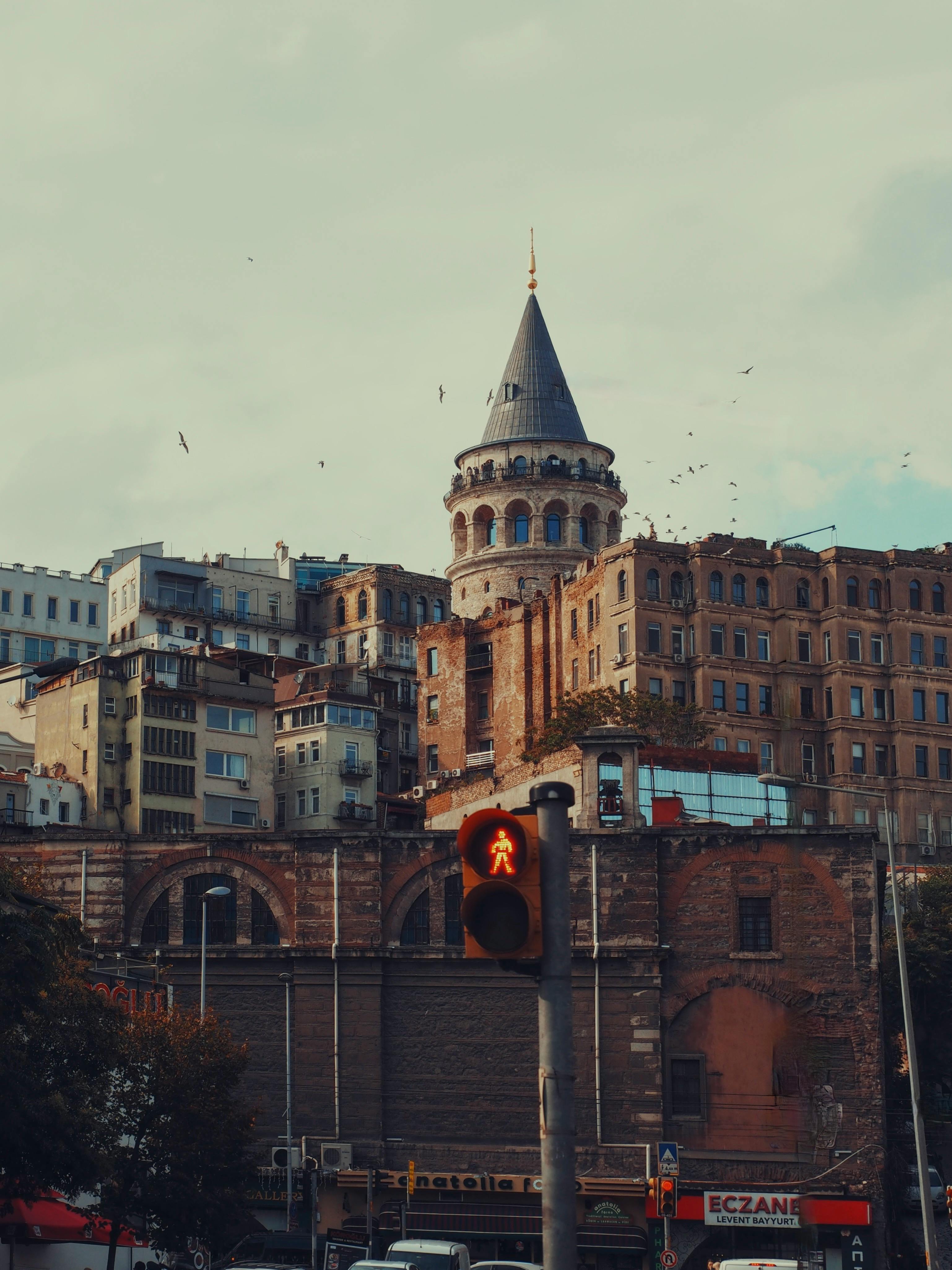 View of the historic Galata Tower surrounded by urban Istanbul architecture. Iconic cityscape.