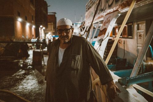 Free Portrait of a fisherman at a port in Ras El-Bar, Egypt at night. Stock Photo