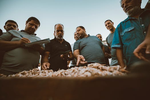 A group of Egyptian fishermen gather at the Ras El-Bar fish market to evaluate the day's catch.