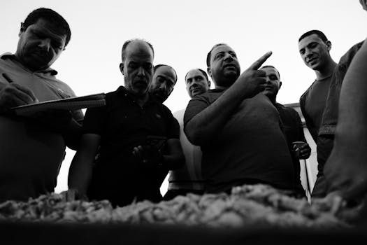 A group of fishermen engaged in lively conversation at a fish market in Ras El-Bar, Egypt.