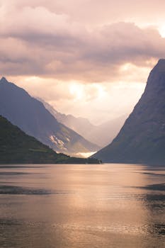 Captivating view of a Norwegian fjord under dramatic sunset skies.