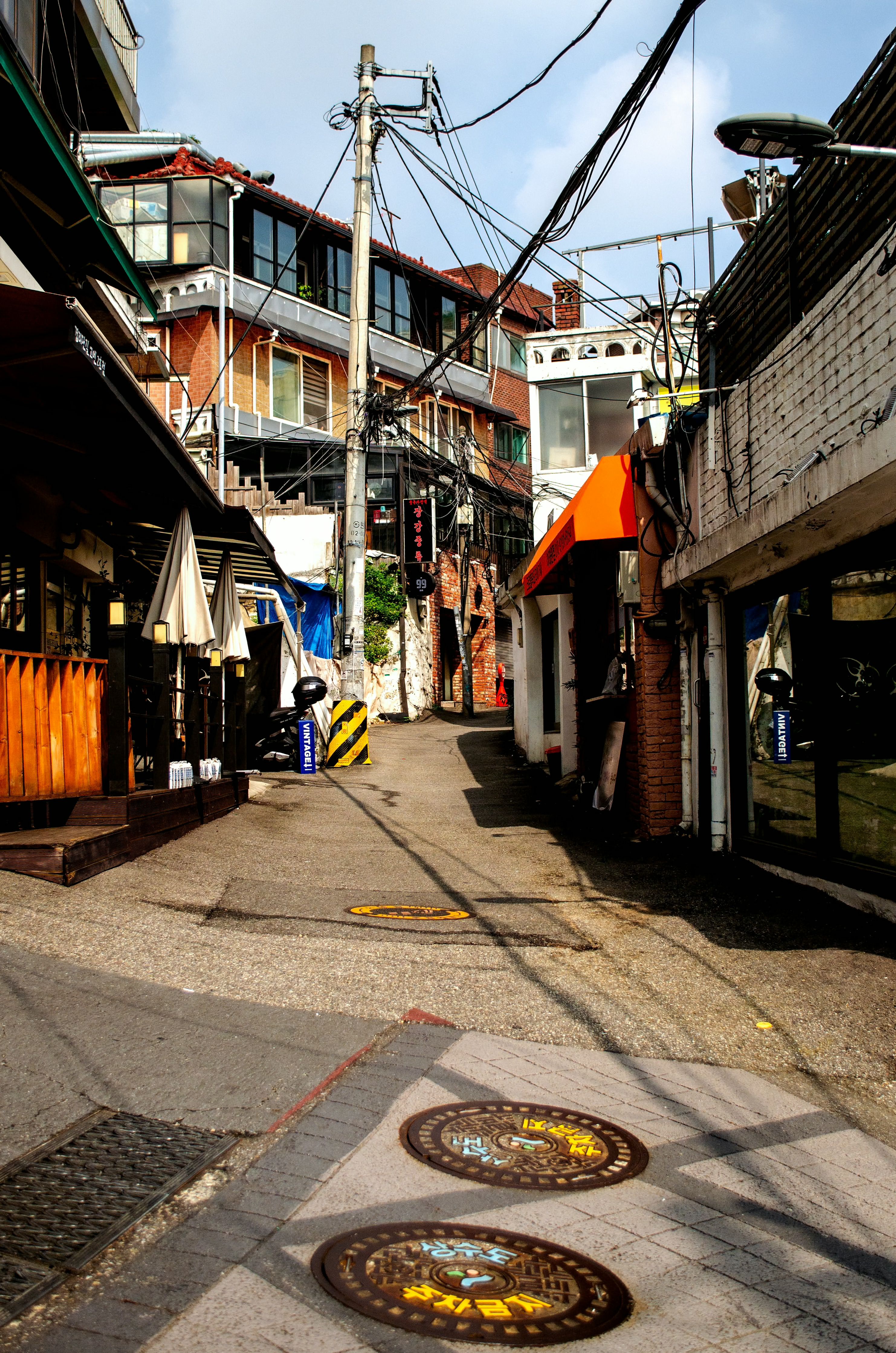 A vibrant street scene in an alleyway of Seoul, South Korea, showcasing urban architecture.