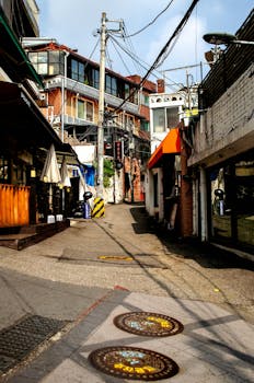 A vibrant street scene in an alleyway of Seoul, South Korea, showcasing urban architecture.