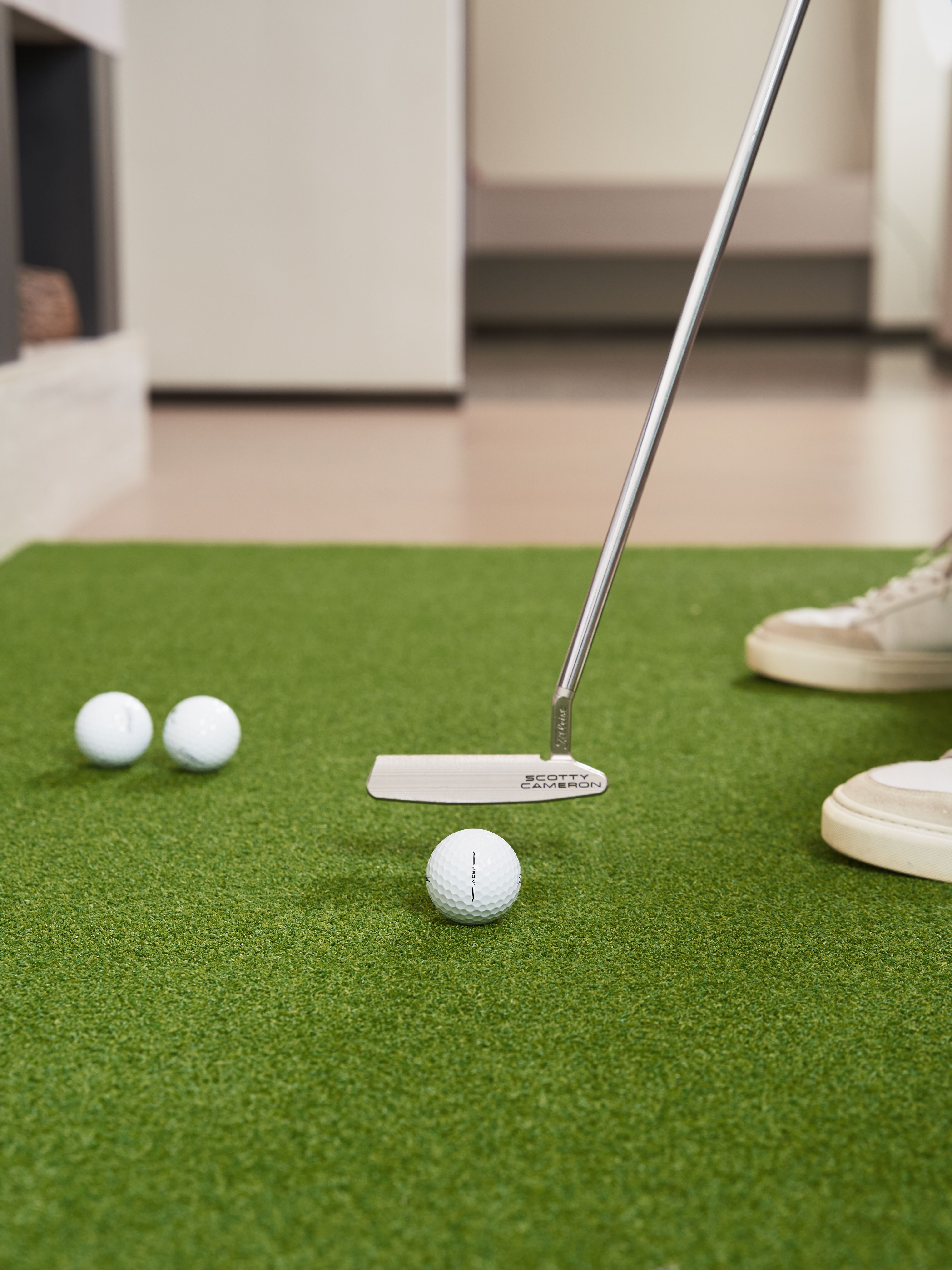 Indoor Golf Practice with Putter and Balls · Free Stock Photo