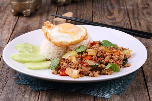 Savor the flavors of Thai basil beef stir-fry served with rice and a fried egg.