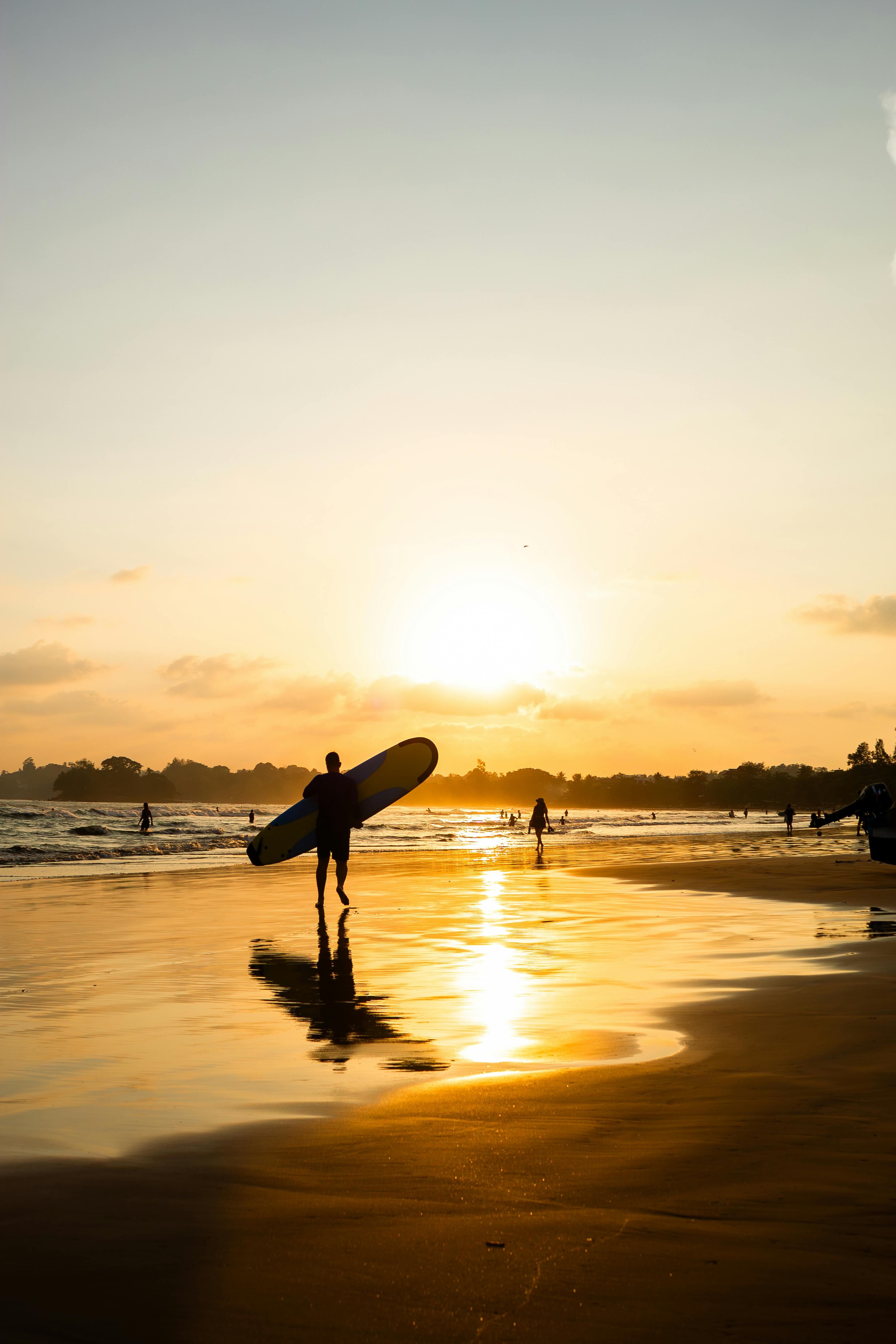 People Walking with Surfboards on Beach at Sunset · Free Stock Photo
