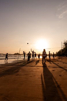 A lively beach volleyball game at sunset on Weligama Beach, Sri Lanka.