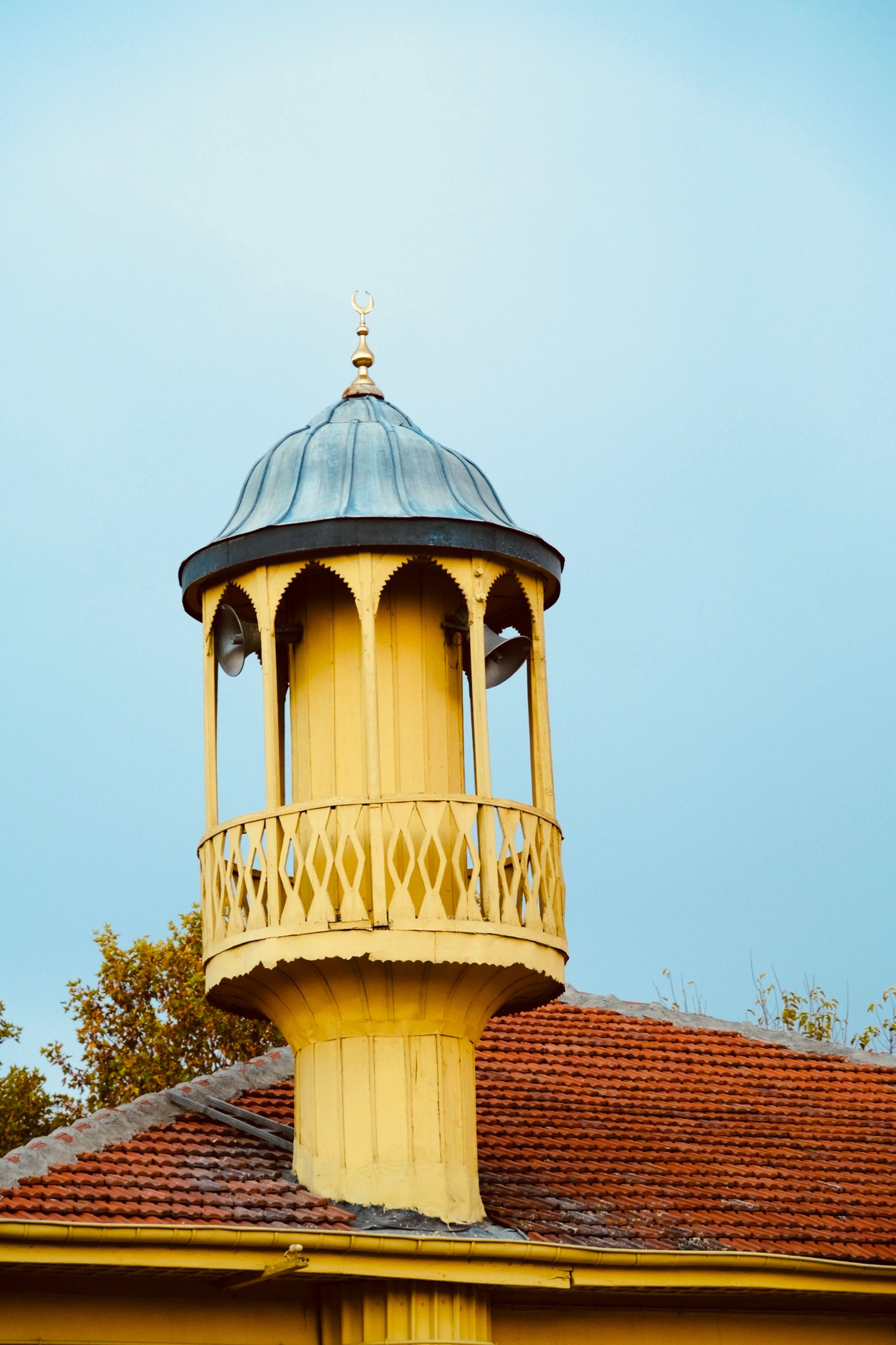Vintage Yellow Tower Against Clear Sky · Free Stock Photo