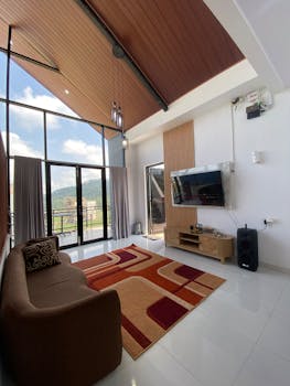 Spacious modern living room with large windows overlooking scenic outdoor views.