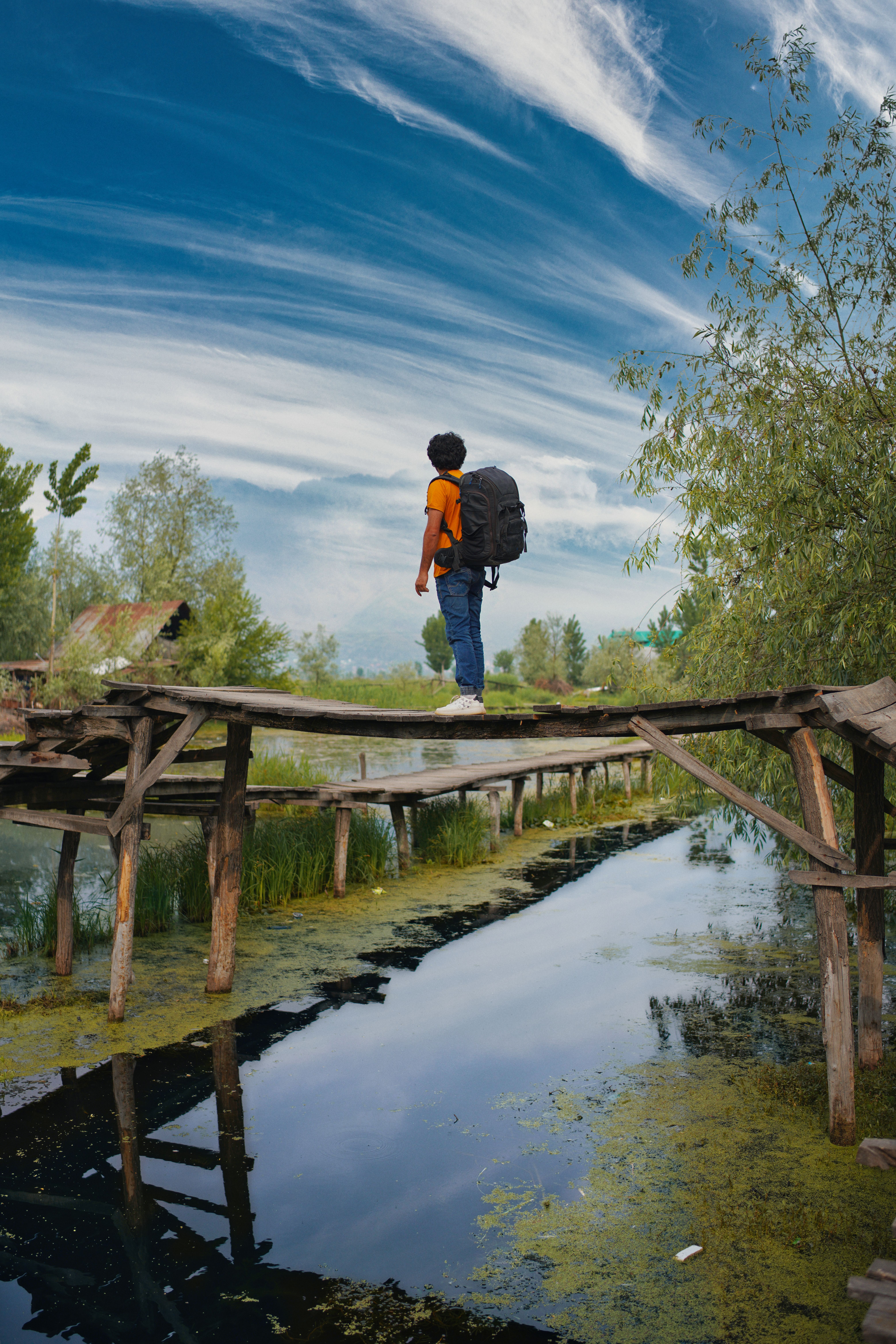 Hiker Crossing Rustic Wooden Bridge in Nature · Free Stock Photo