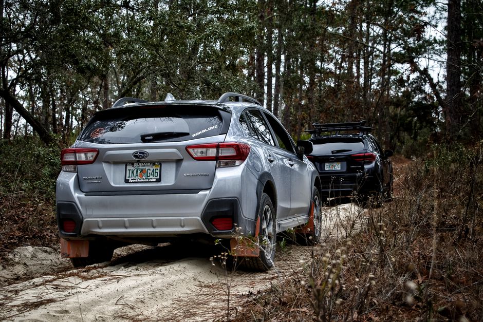 Two vehicles navigating a forest trail, perfect for off-road enthusiasts.