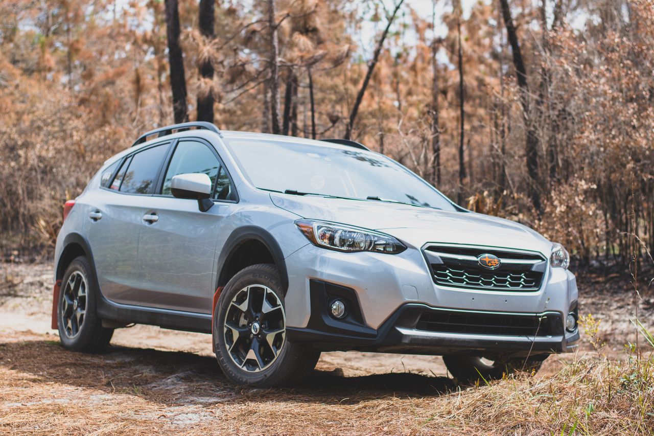 a stylish compact suv set against a backdrop of autumn trees in a fore