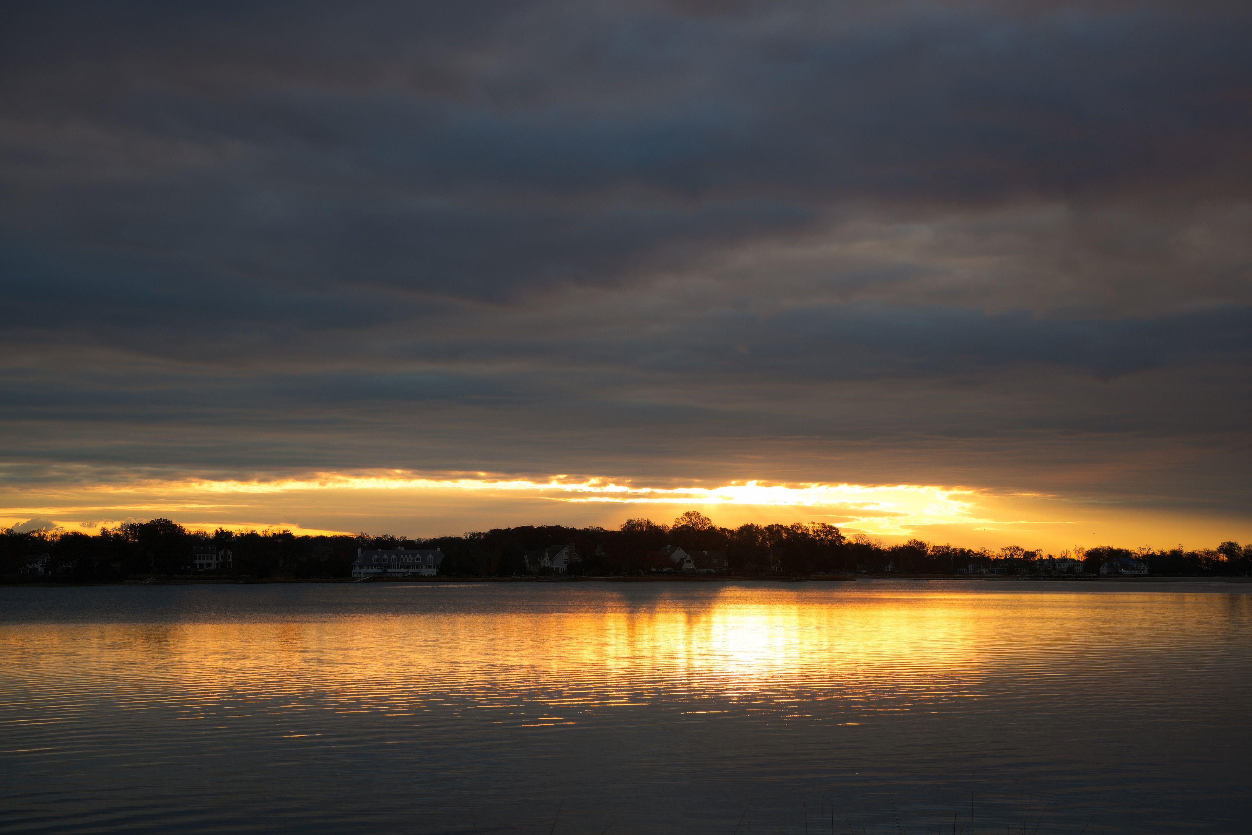 Serene Sunset Over Tranquil Lake Waters · Free Stock Photo