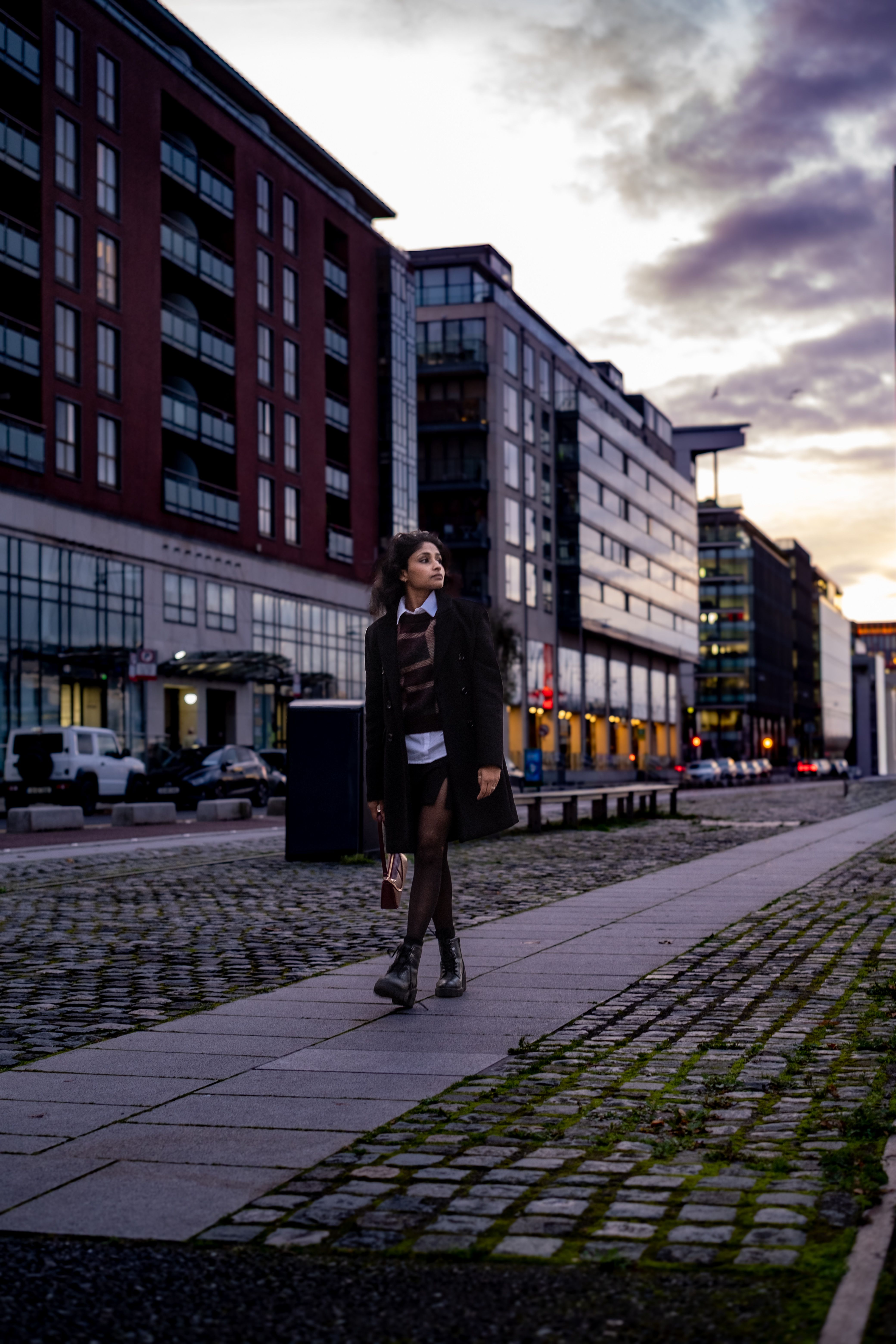 Stylish Woman Walking in Urban Setting at Twilight · Free Stock Photo
