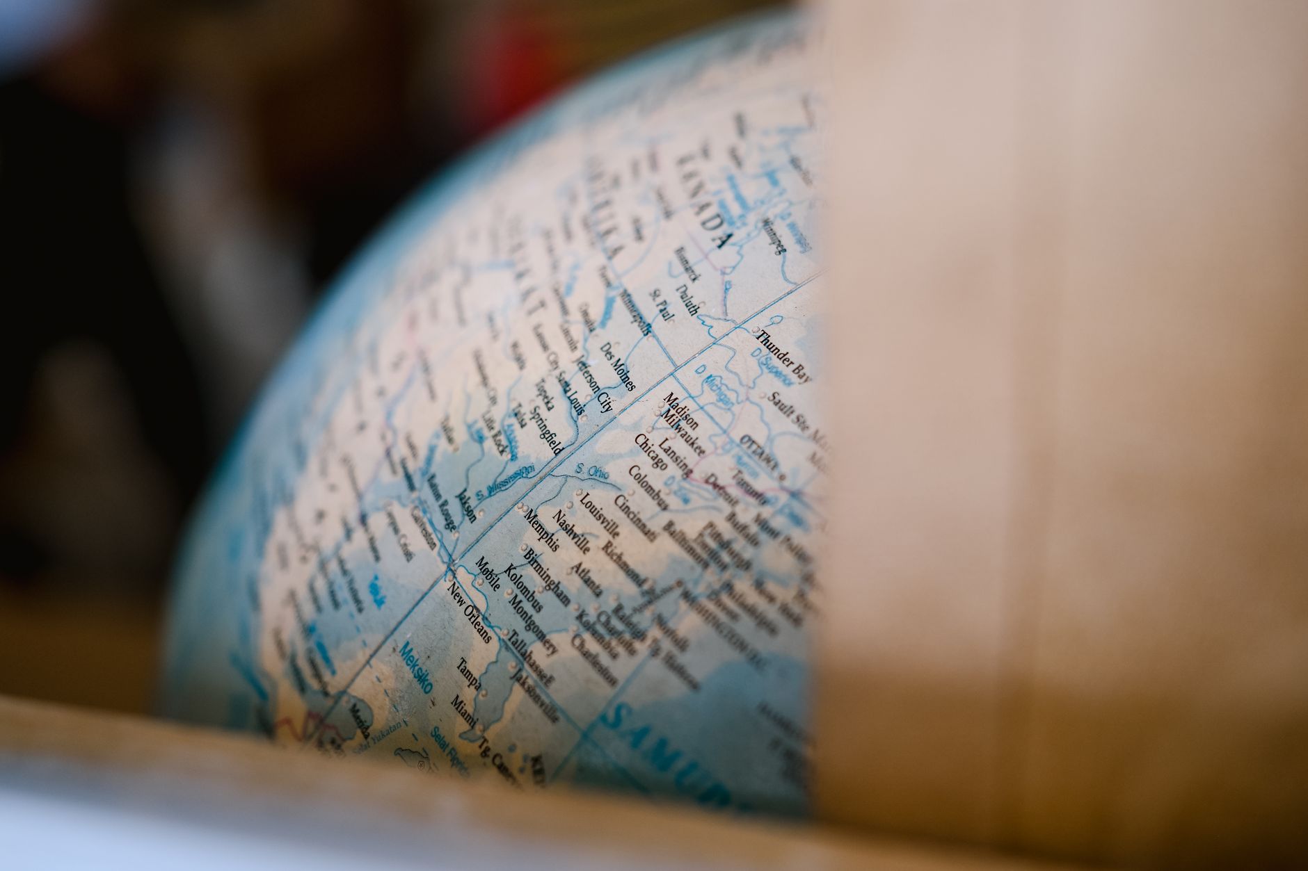 Detailed close-up of a vintage world globe showing geographical locations. Perfect for travel themes.
