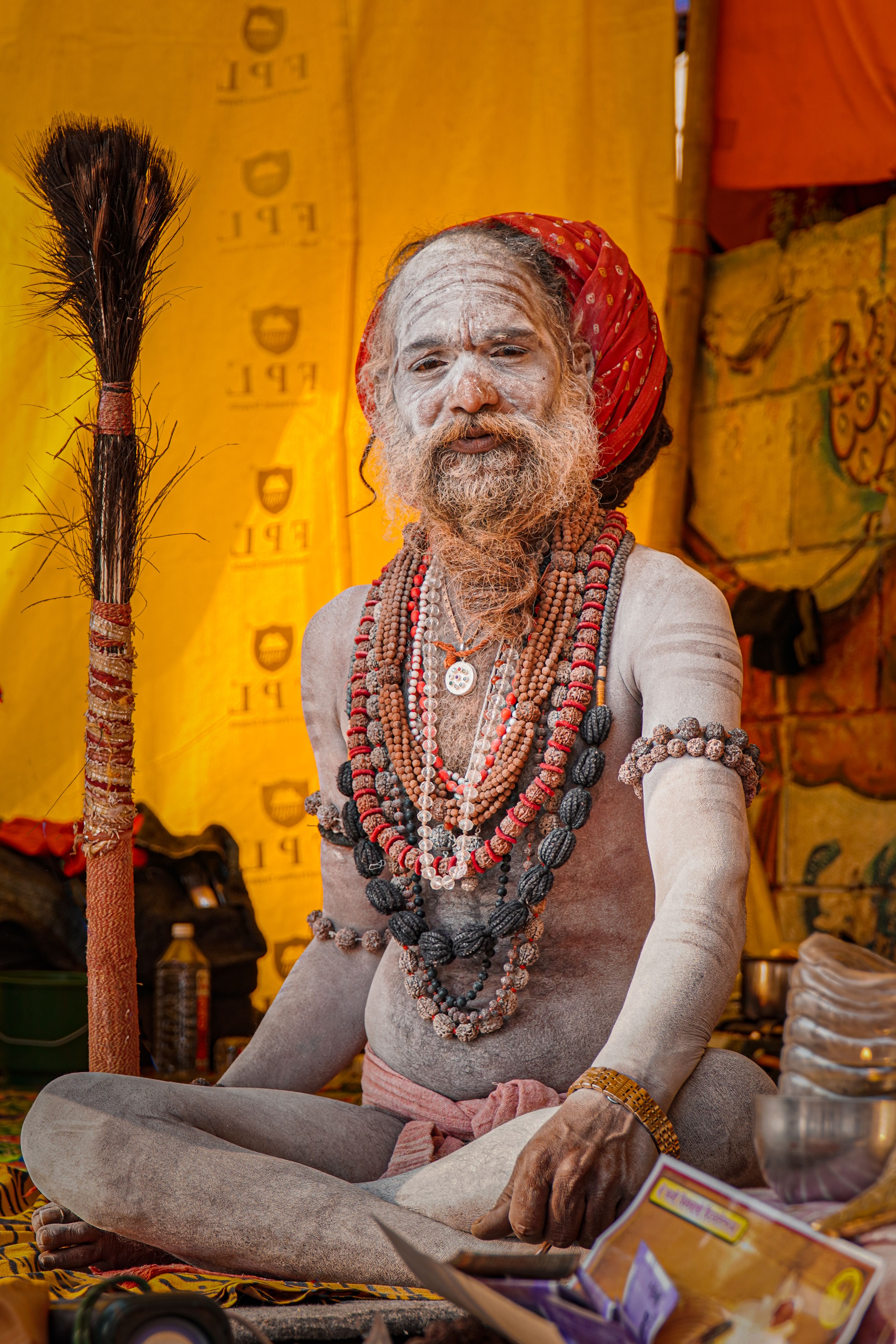 Portrait of a Naga Sadhu with ash-washed body and red turban in Varanasi, India.