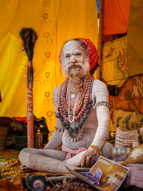 Free Naga Sadhu in a colorful tent during Kumbh Mela pilgrimage, Varanasi, India. Stock Photo