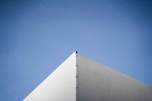 A minimalist architectural corner against a vivid blue sky showcasing simplicity and modern design.