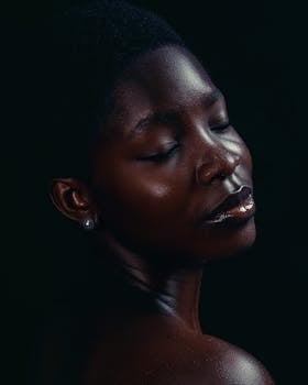 Artistic portrait of an African woman with closed eyes, capturing serene beauty.