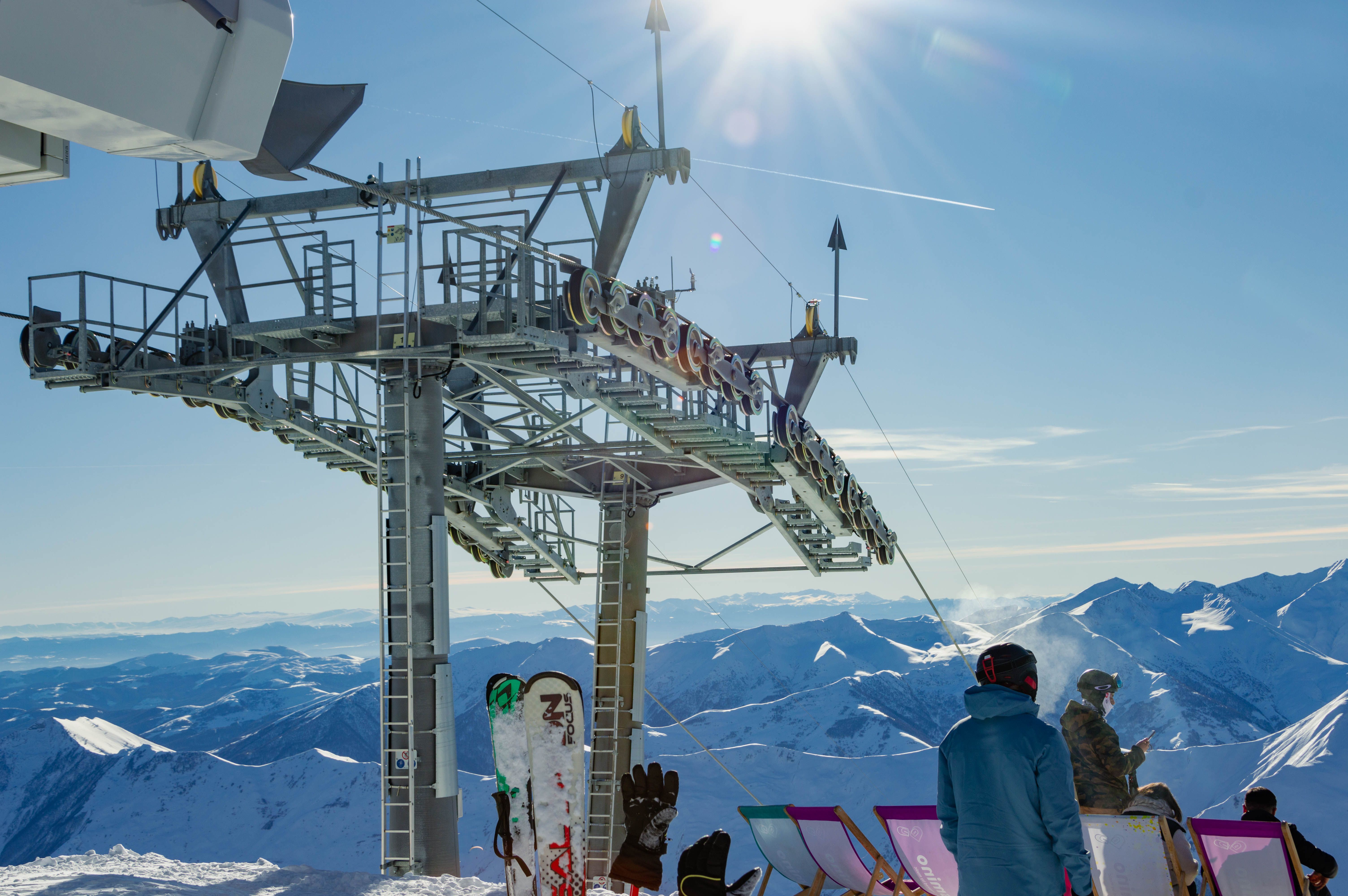 Skiers enjoying a sunny winter day at Gudauri Ski Resort with stunning mountain views.