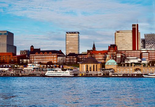 A vibrant view of Hamburg's architectural skyline viewed across the Elbe River.
