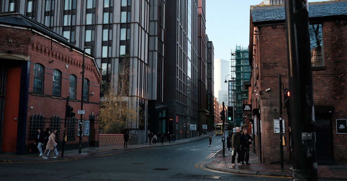 Street view showcasing a blend of historic and modern architecture with pedestrians.