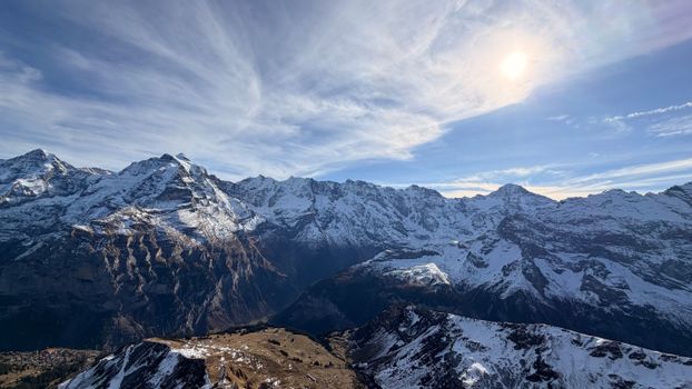 Stunning view of the snow-capped Alps under a bright sky in Lauterbrunnen, Switzerland.