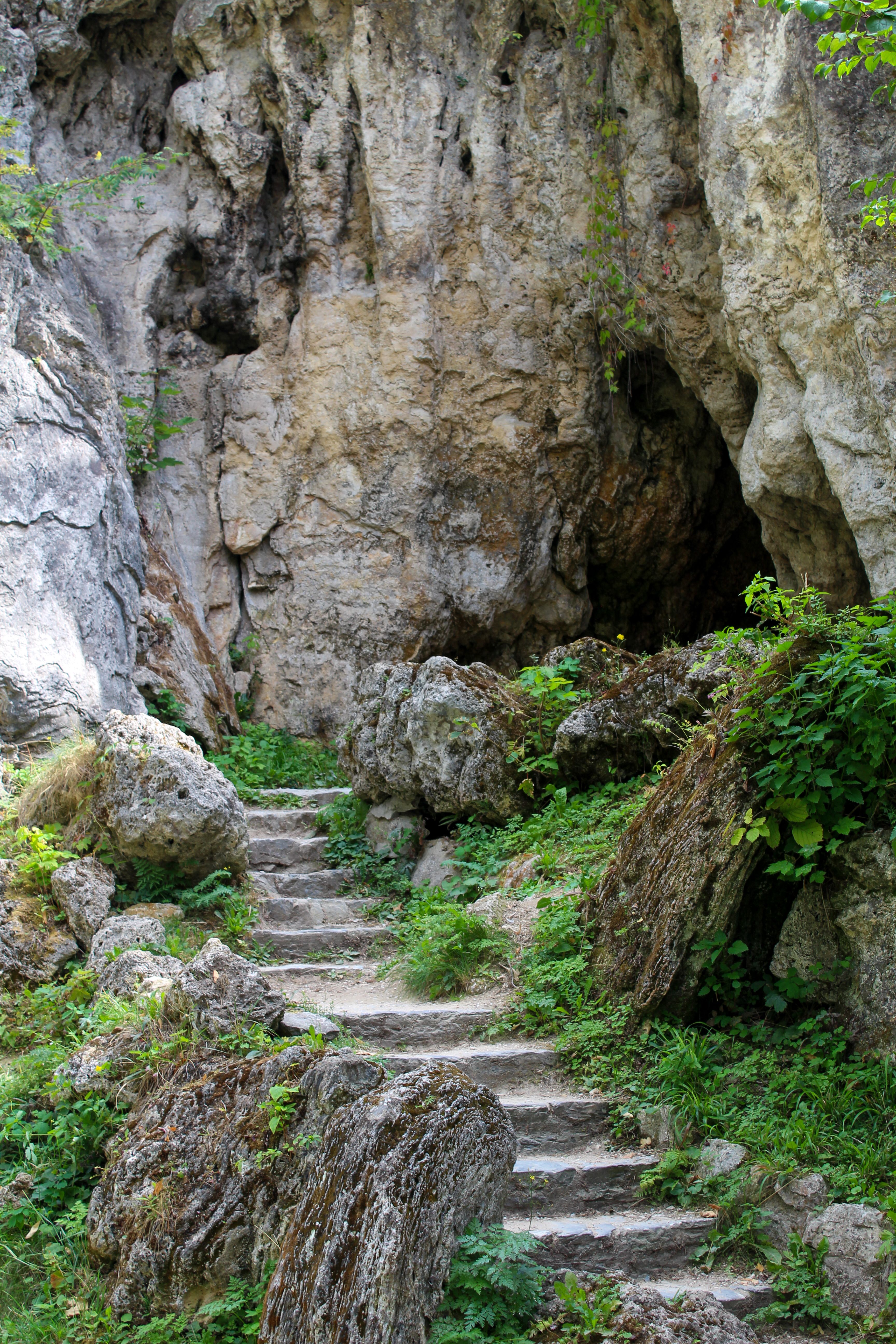 Stone steps leading to rocky cave entrance · Free Stock Photo