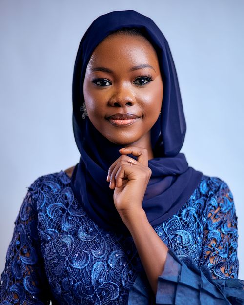 Free Portrait of a woman in a blue hijab, showcasing elegance and culture. Stock Photo