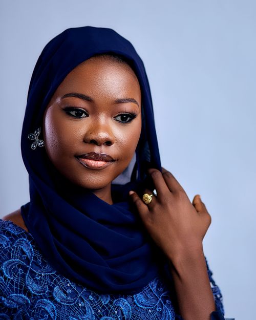 Free Beautiful portrait of a woman wearing a blue hijab, exuding grace and elegance. Stock Photo
