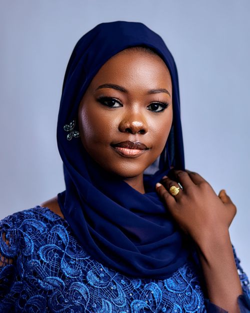 Free Stunning portrait of a woman wearing a blue hijab against a soft background. Stock Photo