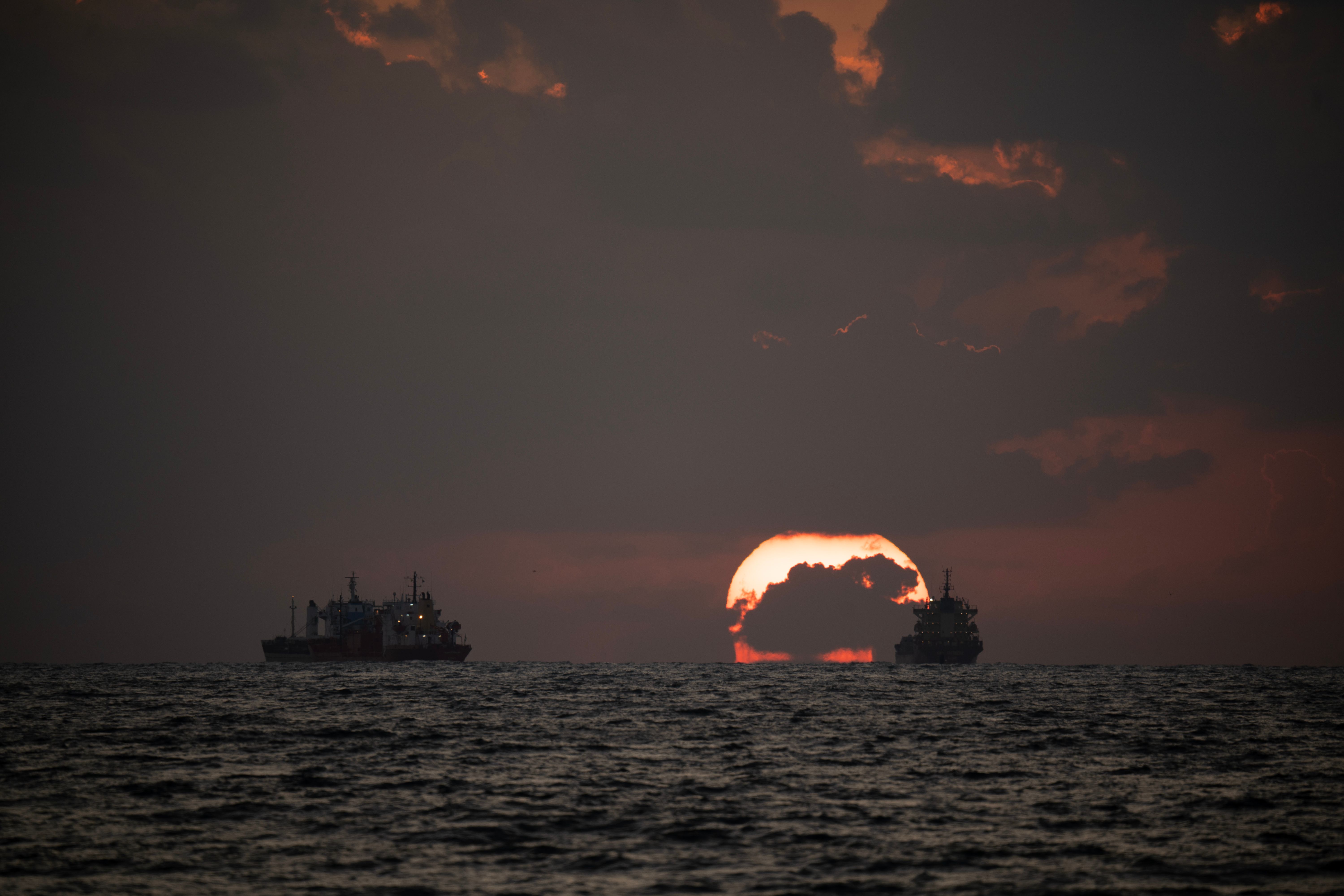 Dramatic Ocean Sunset with Ships Silhouetted · Free Stock Photo