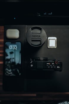 Discover a moody flat lay featuring photography gear and tech gadgets, perfect for creatives.