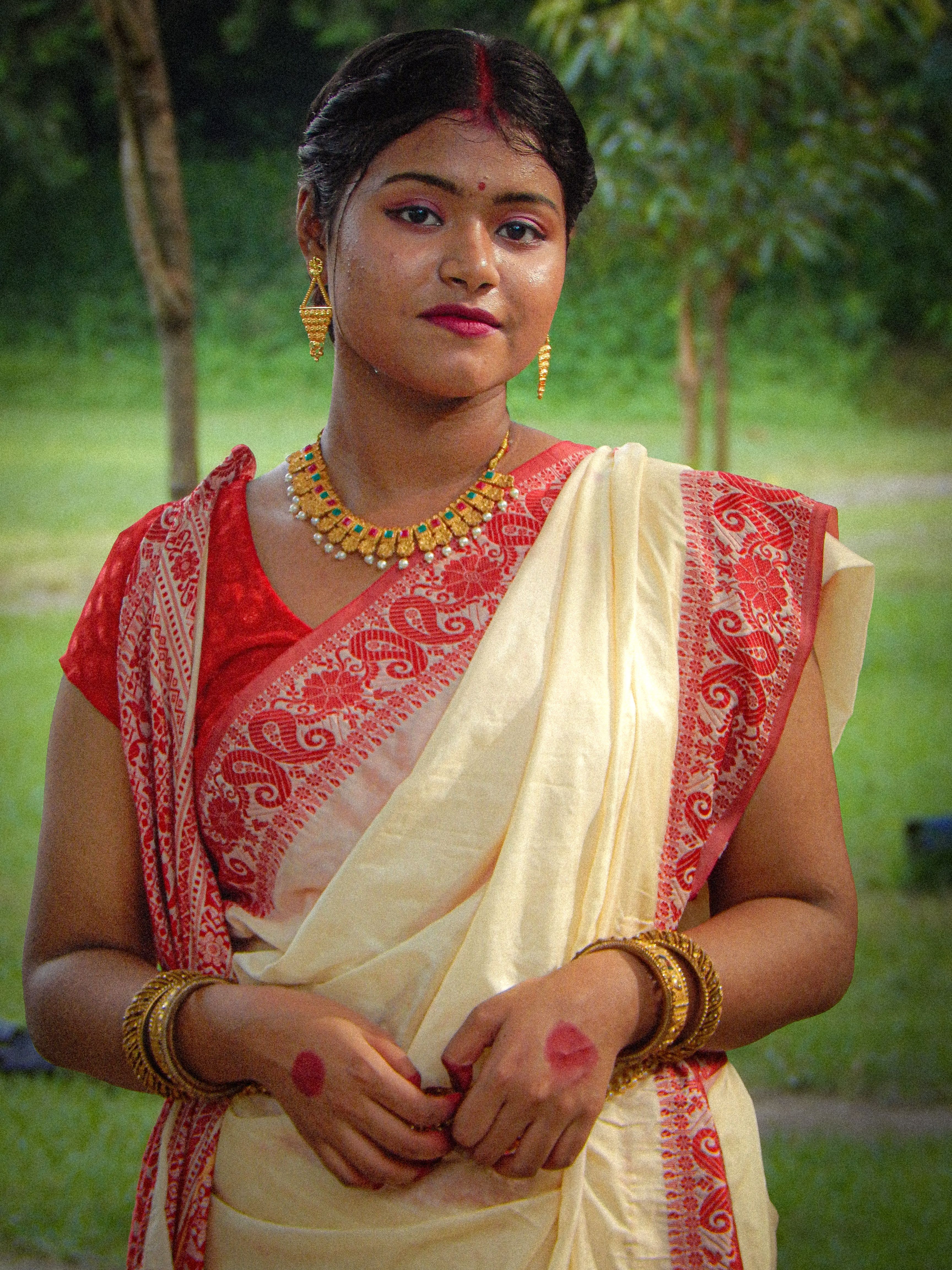 Portrait of a South Asian woman in traditional attire outdoors, showcasing cultural elegance.