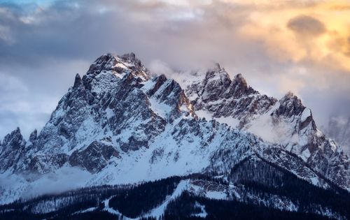 Free Breathtaking view of the snow-covered Dolomites with colorful sunset clouds. Stock Photo