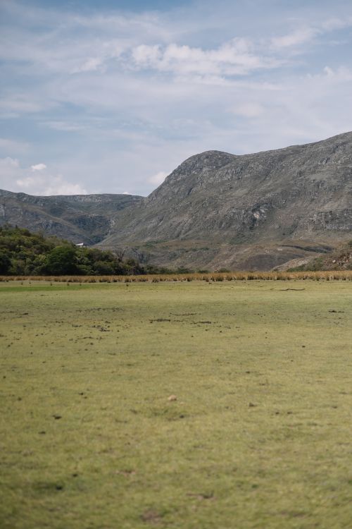 Free Breathtaking view of grassy plains and mountains in Lapinha Da Serra, Brazil. Stock Photo