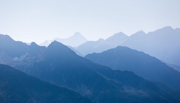 A tranquil view of the blue mountain peaks at dusk, capturing nature's beauty.