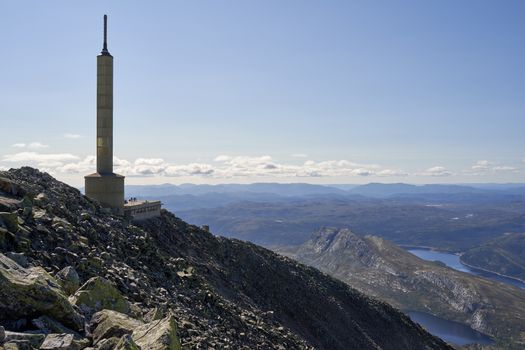 Breathtaking view from Gaustatoppen with clear skies, showcasing Telemark's rugged landscape and distant horizons.