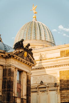 View of the dome at Dresden's Academy of Fine Arts bathed in warm sunlight.