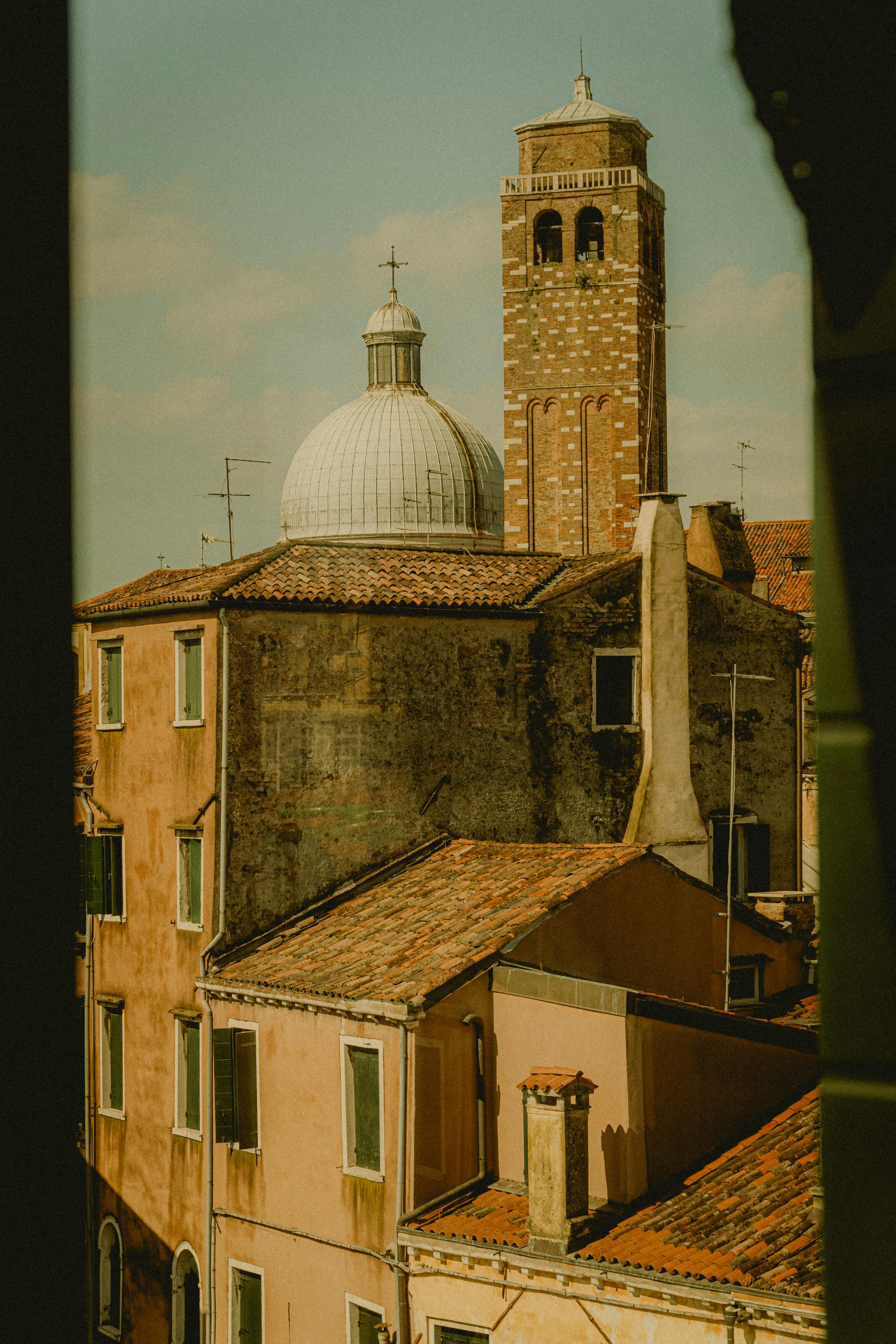 A picturesque view of Venetian buildings and dome with a classic summer vibe.