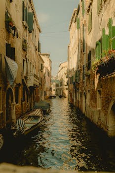 Explore a picturesque canal in Venice with classic architecture and gondolas.